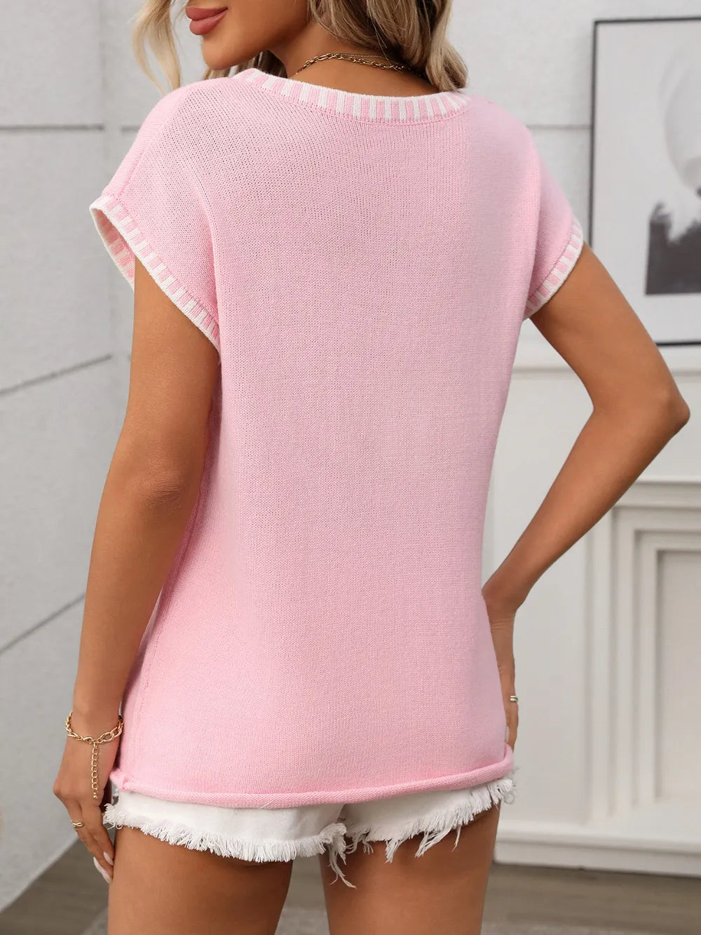 Folded Women's Contrast Trim V-Neck Short Sleeve Knit Top on table