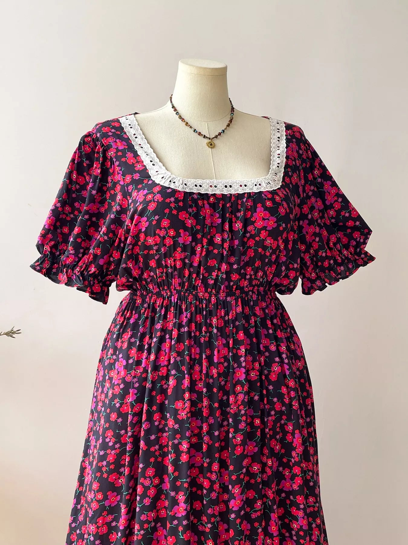 Close-up of neckline on plus size floral square neck short sleeve dress