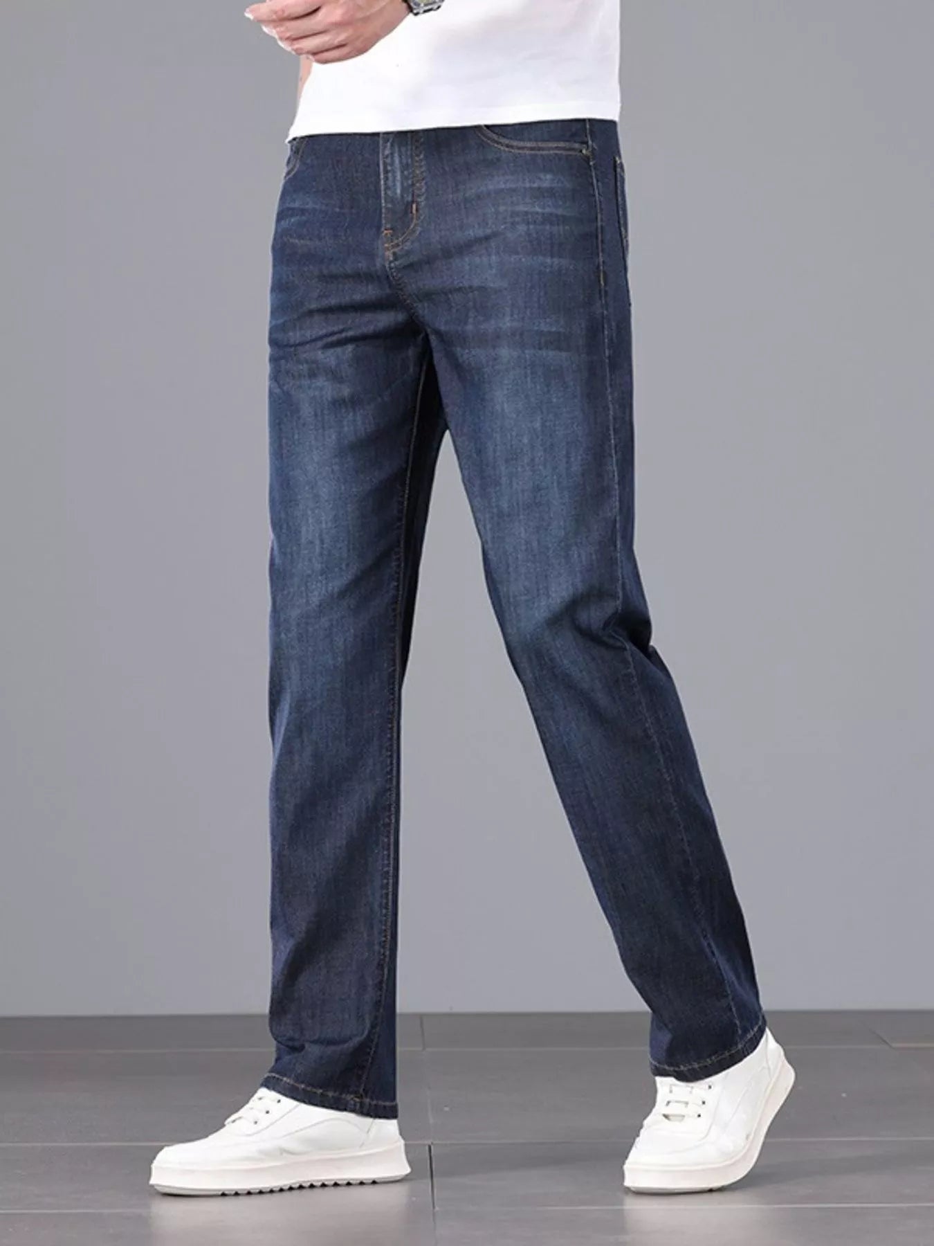 Men's straight fit wash jeans on model walking