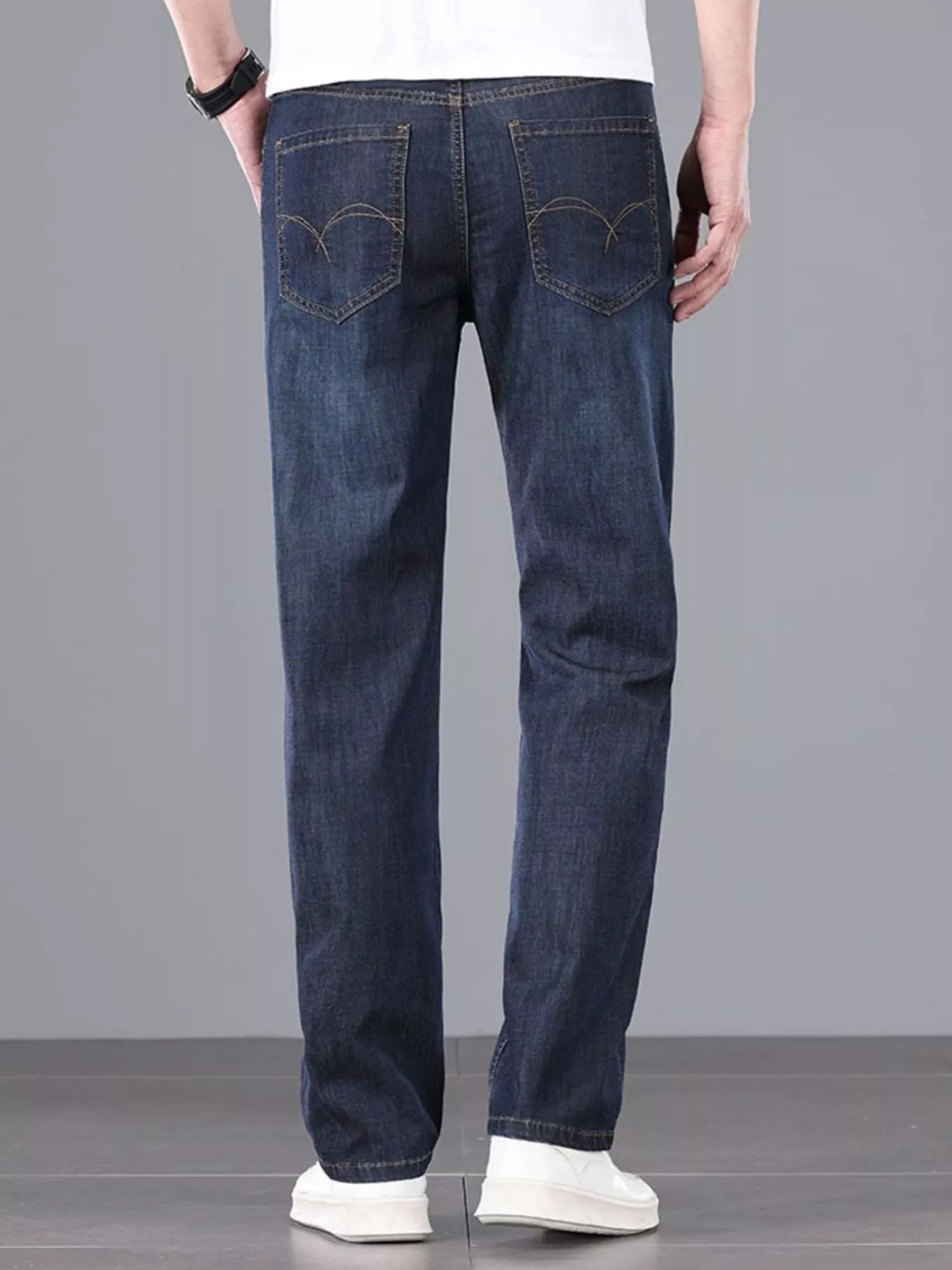 Men's straight fit wash jeans waistband close-up