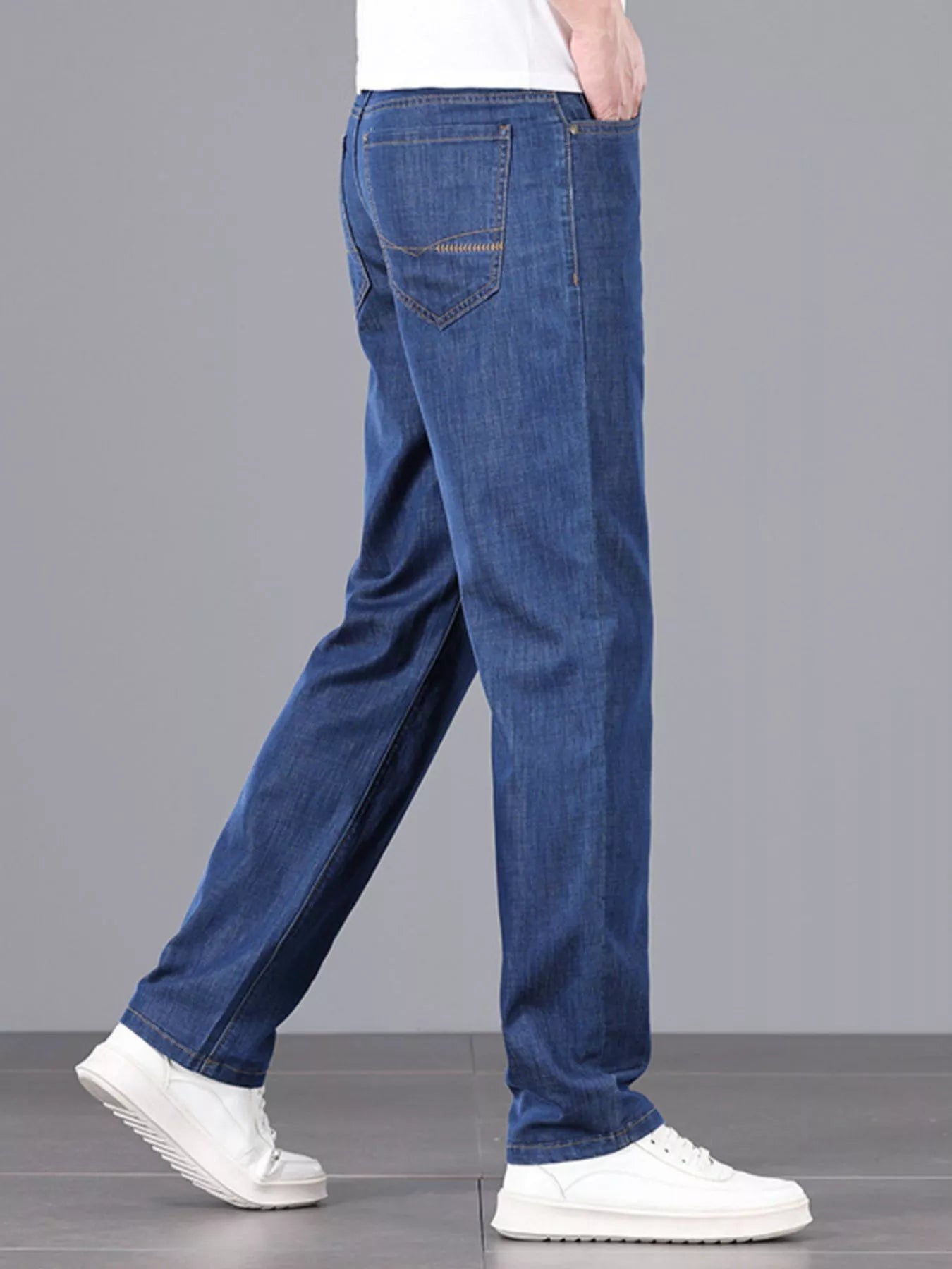 Comfortable men's straight leg jeans on model walking