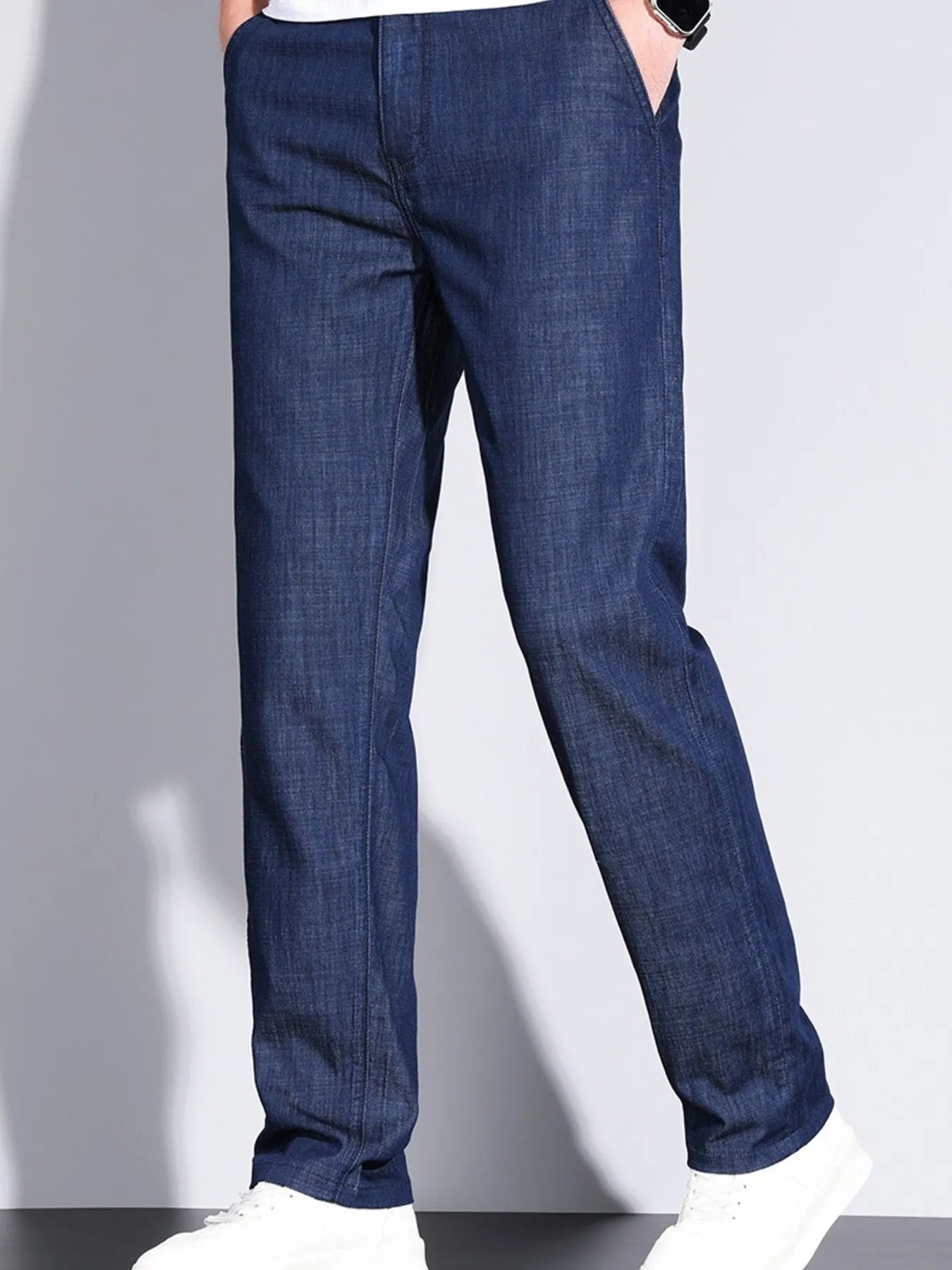 Men’s denim straight leg jeans paired with sneakers