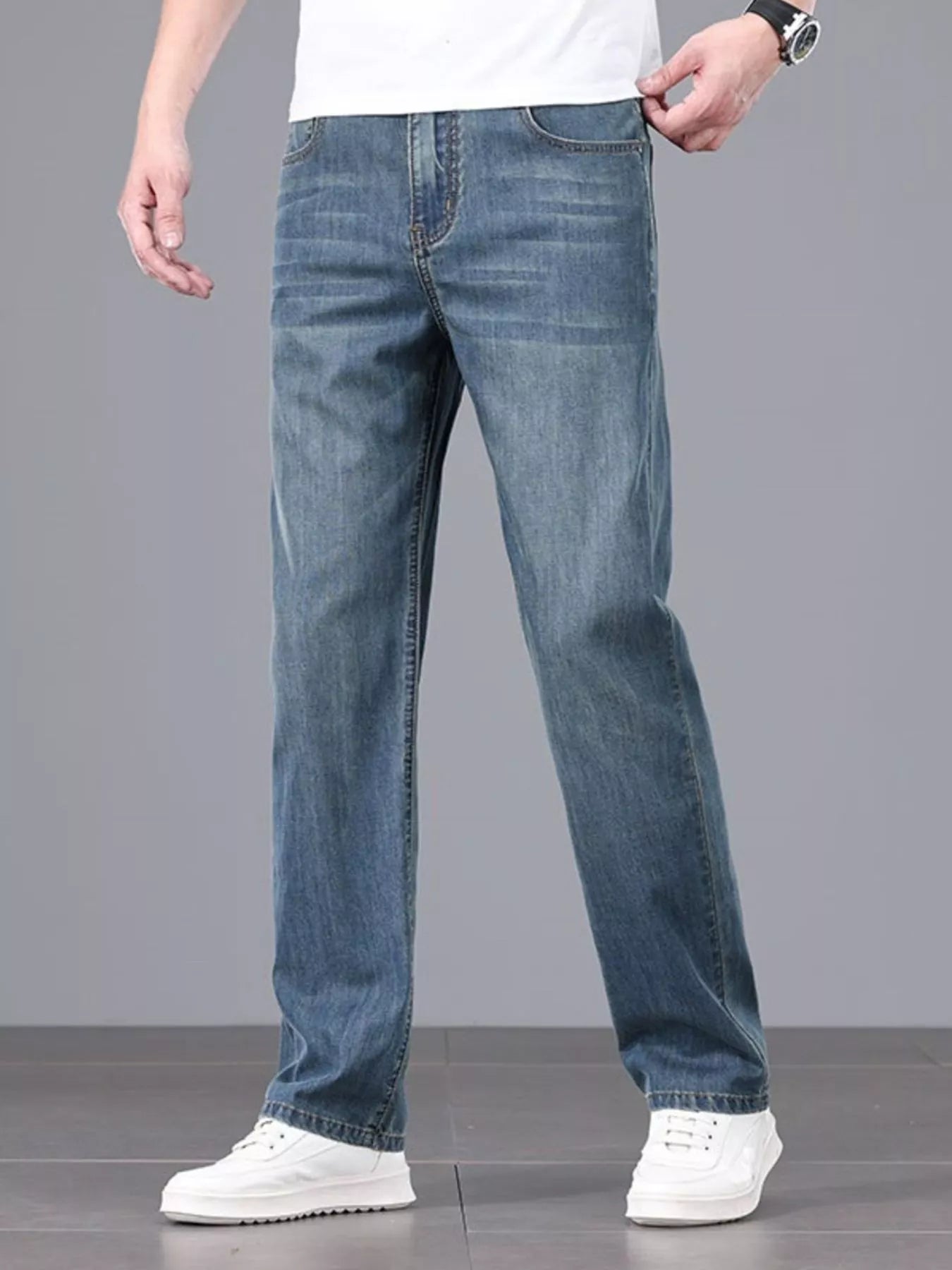 Men's straight fit wash jeans folded flat lay